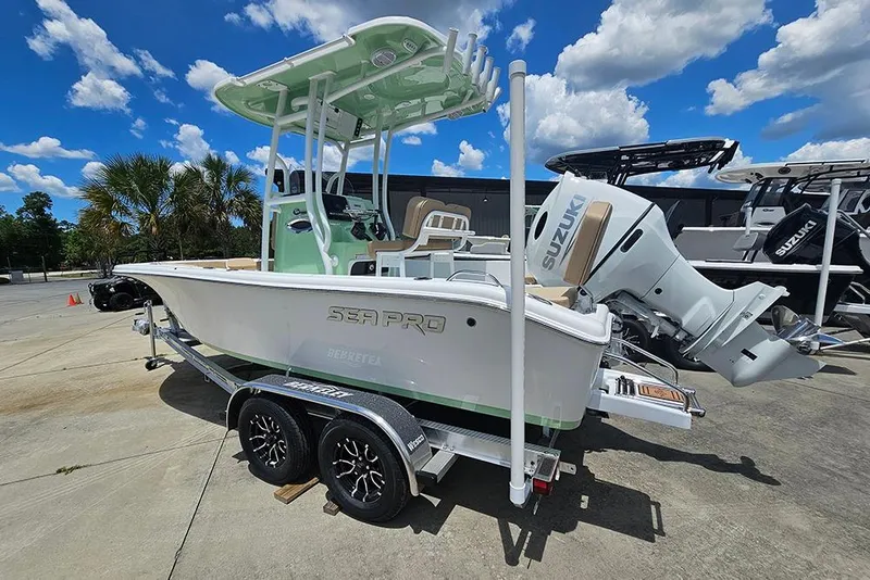 Slide: The Image of 2026 Sea Pro 202 Center Console boat with Suzuki engine on trailer, under blue sky. - 3