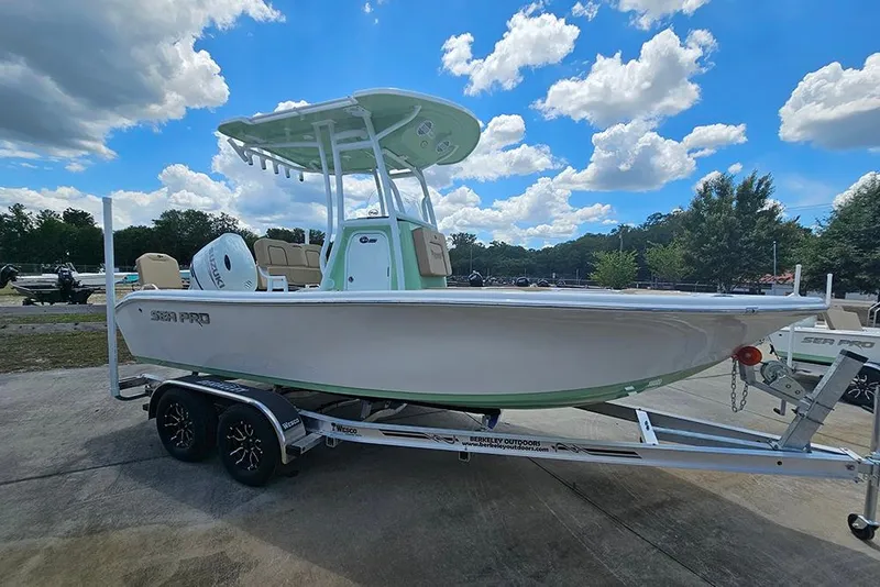 Slide: The Image of 2026 Sea Pro 202 Center Console boat on trailer under a blue sky. - 6