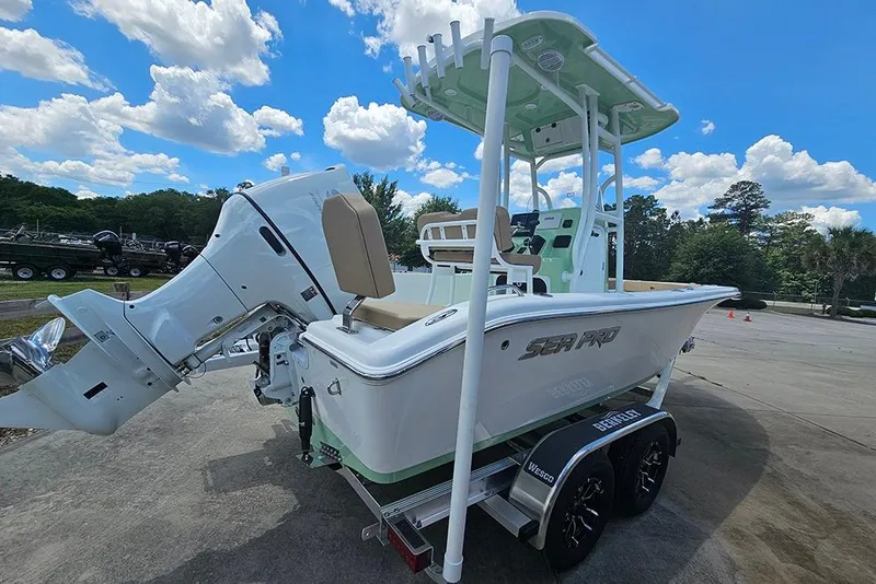 Slide: The Image of 2026 Sea Pro 202 Center Console boat on trailer, under a clear blue sky. - 7