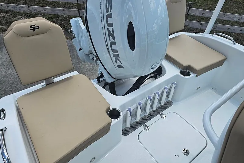 Slide: The Image of 2026 Sea Pro 202 Center Console boat interior with Suzuki engine and beige seating. - 8