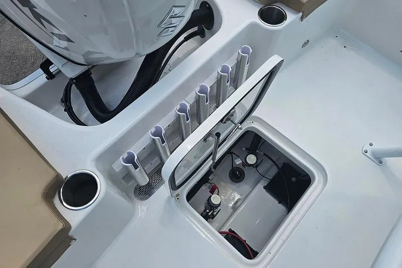 Slide: The Image of 2026 Sea Pro 202 Center Console boat with open storage compartment and rod holders. - 9