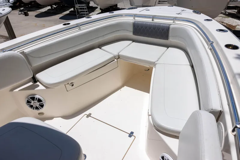 Slide: The Image of 2020 Cobia 262 Center Console boat interior with cushioned seating and stainless steel railings. - 12