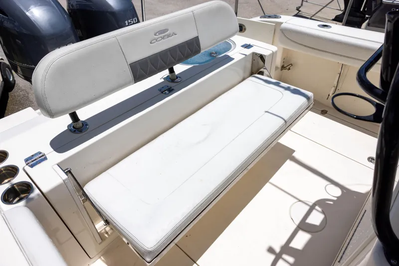 Slide: The Image of 2020 Cobia 262 Center Console boat seating area with dual engines in background. - 13