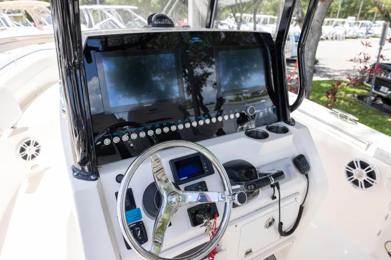 Slide: The Image of 2020 Cobia 262 Center Console boat dashboard with steering wheel and electronic displays. - 6