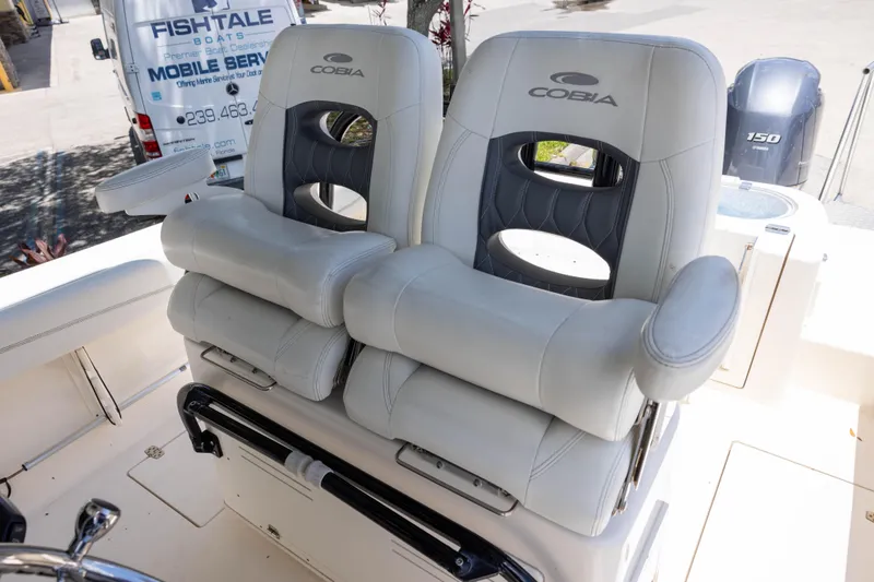 Slide: The Image of 2020 Cobia 262 Center Console boat seats with armrests and logo. - 7