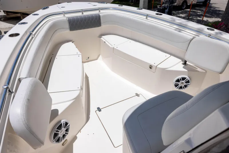 Slide: The Image of 2020 Cobia 262 Center Console boat interior with white seating and speakers. - 8