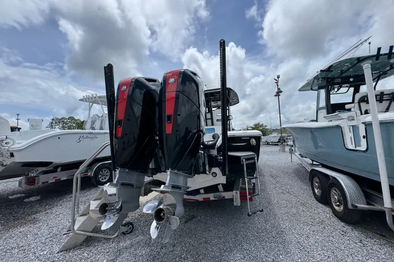 Slide: The Image of 2024 Tidewater 3100 Carolina Bay boat with dual outboard motors on display. - 10