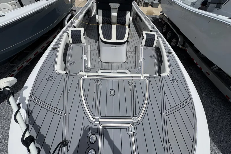 Slide: The Image of 2024 Tidewater 3100 Carolina Bay boat deck with sleek gray design and seating. - 16