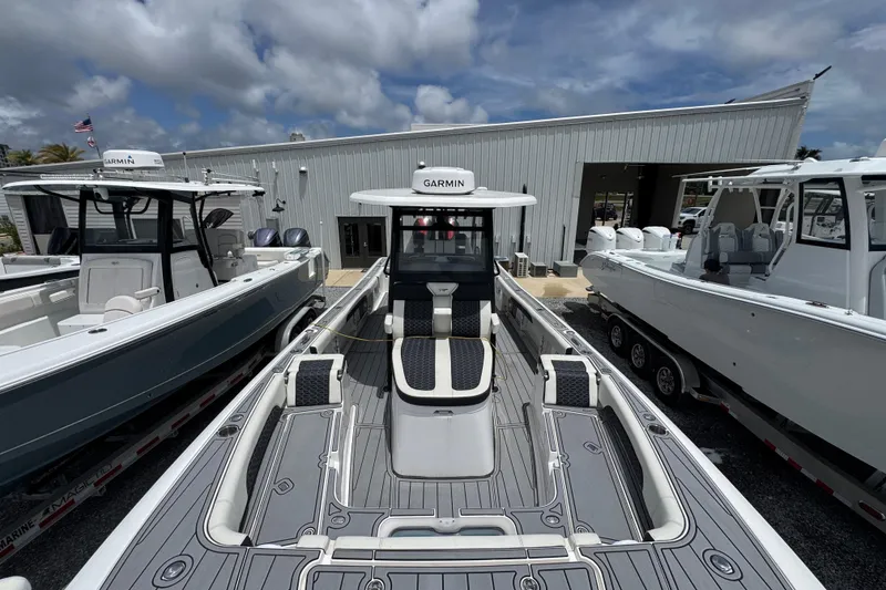 Slide: The Image of 2024 Tidewater 3100 Carolina Bay boat with Garmin equipment, docked at a marina under cloudy skies. - 17