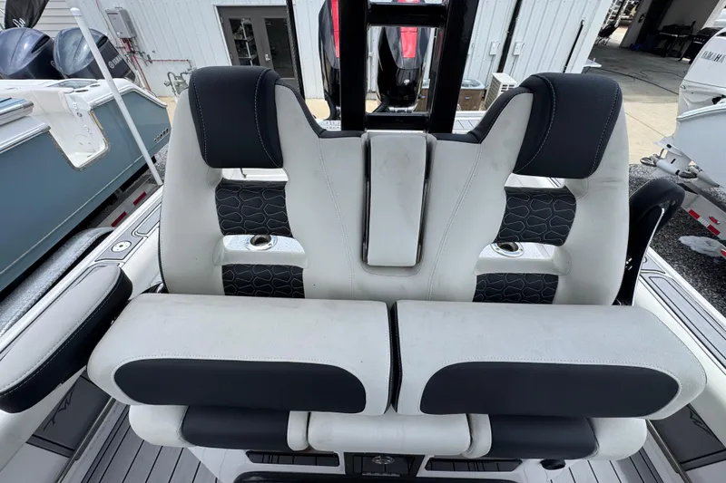 Slide: The Image of 2024 Tidewater 3100 Carolina Bay boat seating with black and white upholstery. - 22