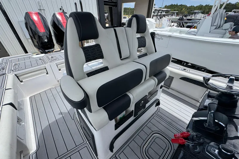 Slide: The Image of 2024 Tidewater 3100 Carolina Bay boat interior with dual seating and modern controls. - 24