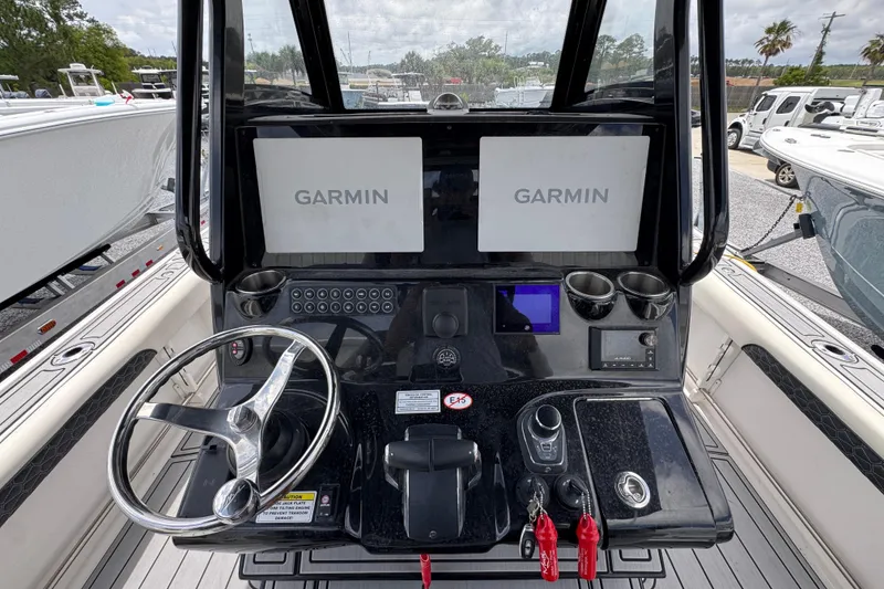 Slide: The Image of 2024 Tidewater 3100 Carolina Bay helm with dual Garmin displays and modern controls. - 26