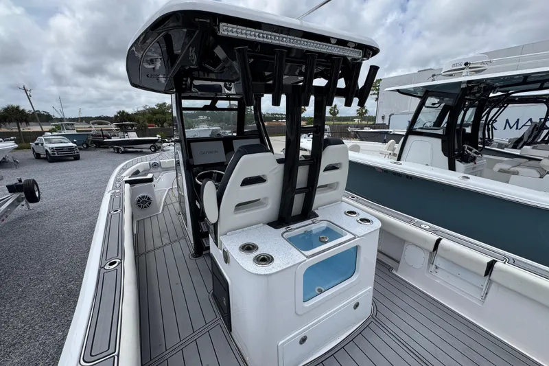 Slide: The Image of 2024 Tidewater 3100 Carolina Bay boat interior with seating and fishing rod holders. - 29
