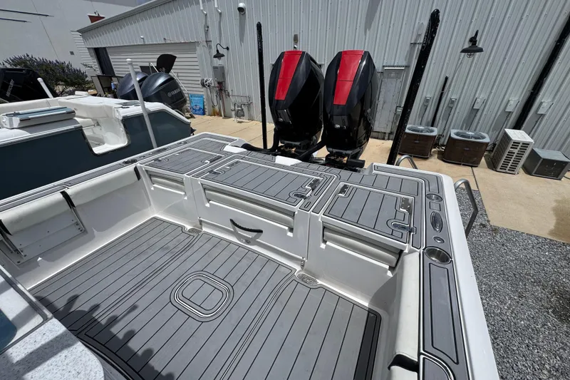Slide: The Image of 2024 Tidewater 3100 Carolina Bay boat with dual outboard motors, featuring spacious deck layout. - 32