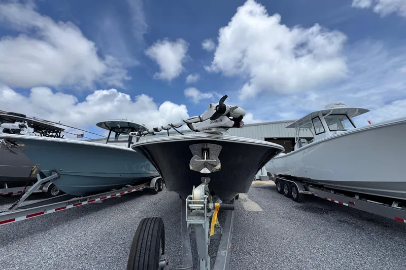 Slide: The Image of 2024 Tidewater 3100 Carolina Bay boat on trailer under blue sky. - 4