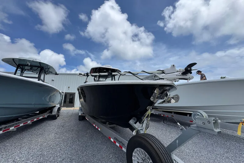 Slide: The Image of 2024 Tidewater 3100 Carolina Bay boat on trailer under cloudy sky. - 5
