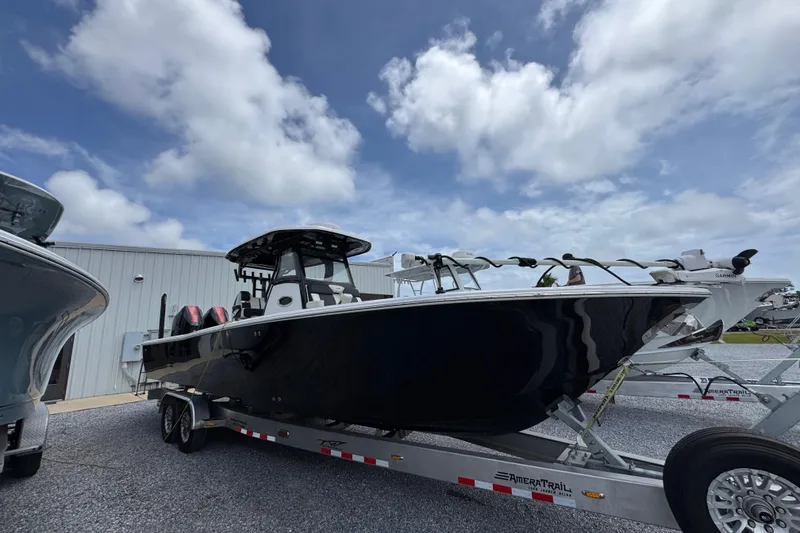 Slide: The Image of 2024 Tidewater 3100 Carolina Bay boat on trailer under cloudy sky. - 6