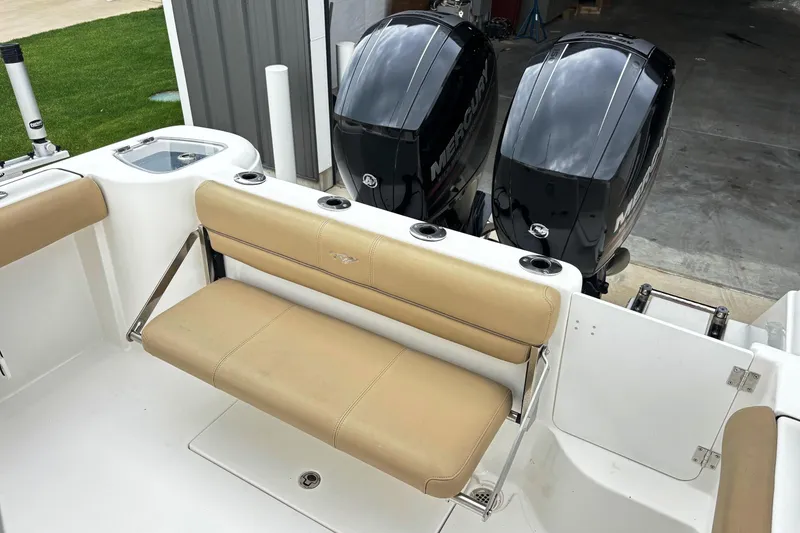 Slide: The Image of 2016 Tidewater 252 CC Adventure boat with dual Mercury engines and tan seating. - 14