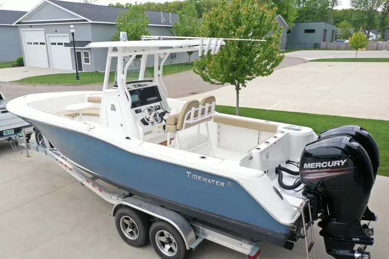 Slide: The Image of 2016 Tidewater 252 CC Adventure boat with dual Mercury engines on a trailer. - 2