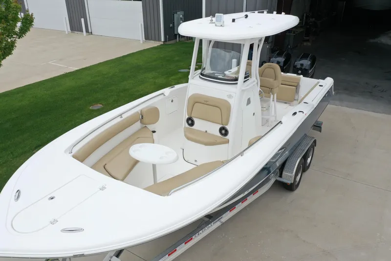 Slide: The Image of 2016 Tidewater 252 CC Adventure boat on trailer, featuring spacious seating and modern design. - 8
