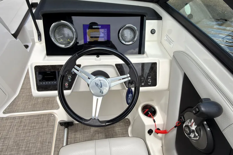 Slide: The Image of 2021 Sea Ray SPX 190 boat dashboard with steering wheel and control panel. - 11