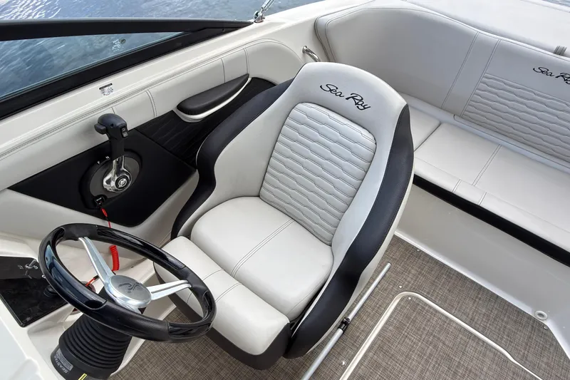 Slide: The Image of 2021 Sea Ray SPX 190 boat interior with steering wheel and seating. - 12