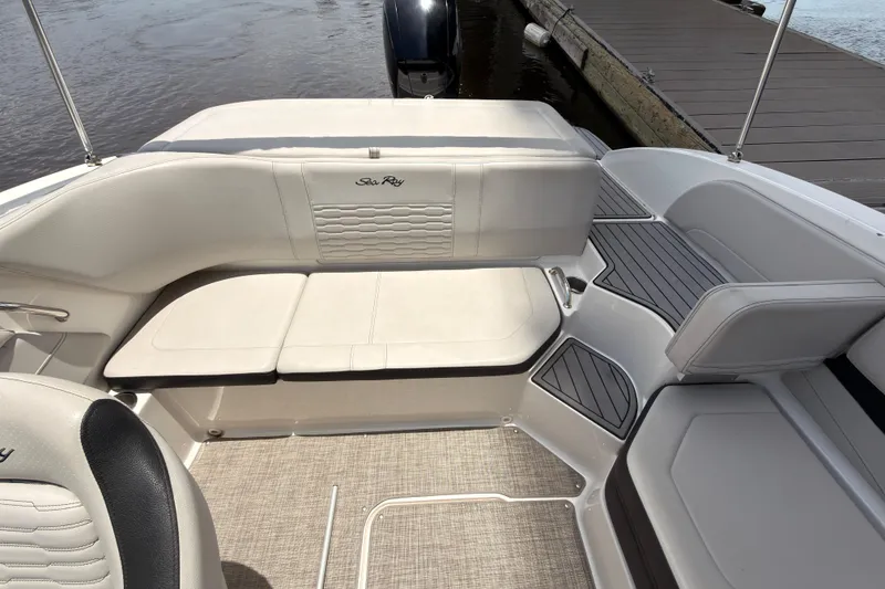 Slide: The Image of 2021 Sea Ray SPX 190 boat interior with white seating and sleek design. - 14