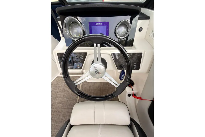 Slide: The Image of 2021 Sea Ray SPX 190 boat dashboard with steering wheel and Simrad display. - 16
