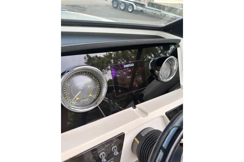 Slide: The Image of Dashboard of 2021 Sea Ray SPX 190 boat featuring Simrad display and gauges. - 18