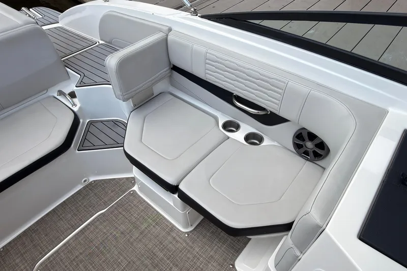 Slide: The Image of 2021 Sea Ray SPX 190 boat interior with cushioned seating and cup holders. - 20