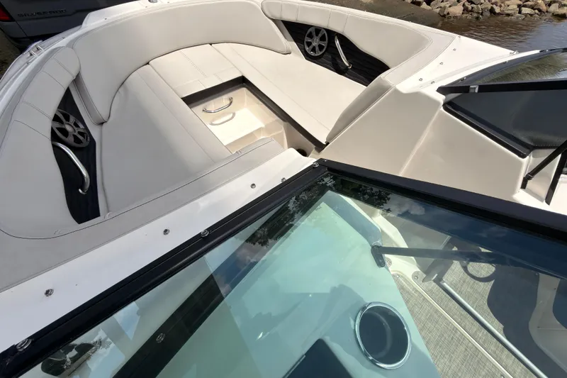 Slide: The Image of 2021 Sea Ray SPX 190 boat interior with white seating and sleek design. - 23