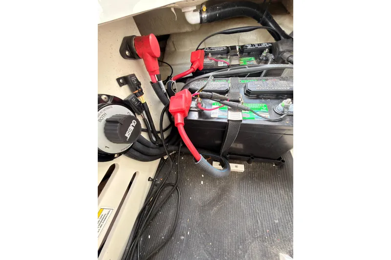 Slide: The Image of Battery compartment of a 2021 Sea Ray SPX 190 boat with wiring and connections. - 28