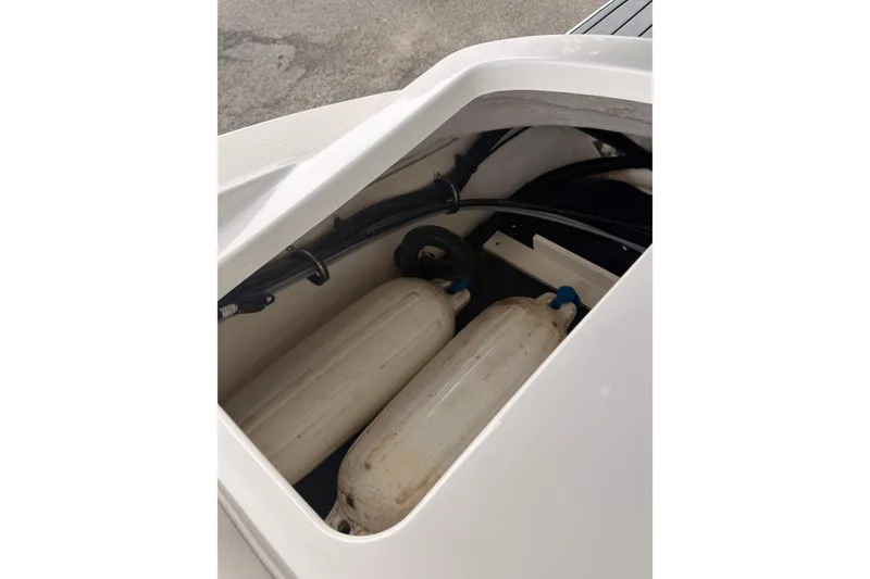 Slide: The Image of Storage compartment of 2021 Sea Ray SPX 190 boat with fenders inside. - 32