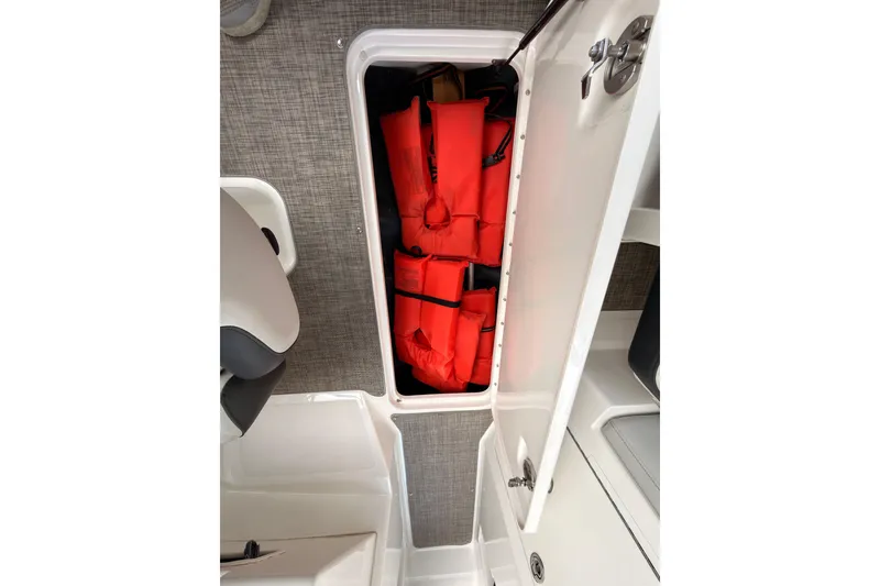 Slide: The Image of Storage compartment with life jackets on a 2021 Sea Ray SPX 190 boat. - 34
