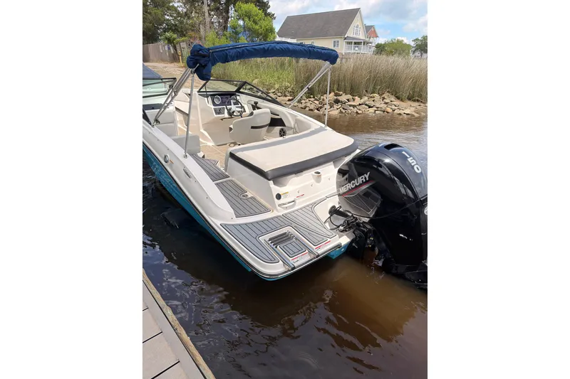 Slide: The Image of 2021 Sea Ray SPX 190 boat docked with Mercury outboard motor. - 4