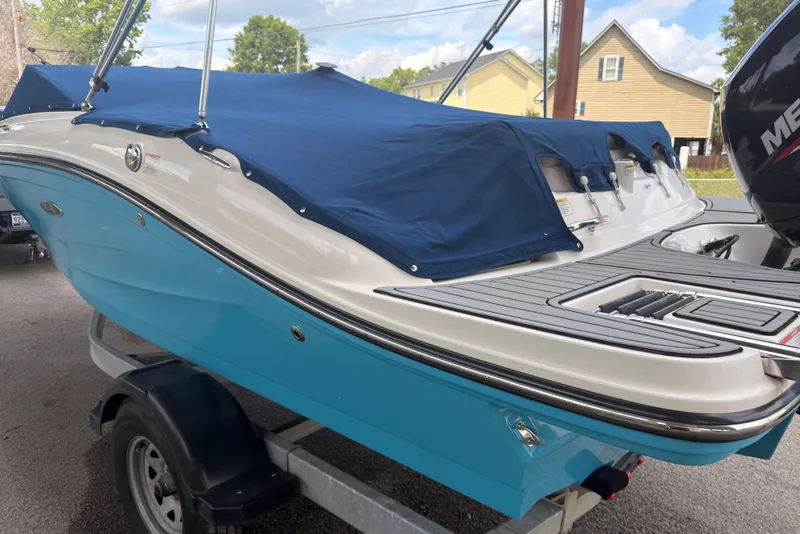 Slide: The Image of 2021 Sea Ray SPX 190 boat with blue cover on trailer. - 41