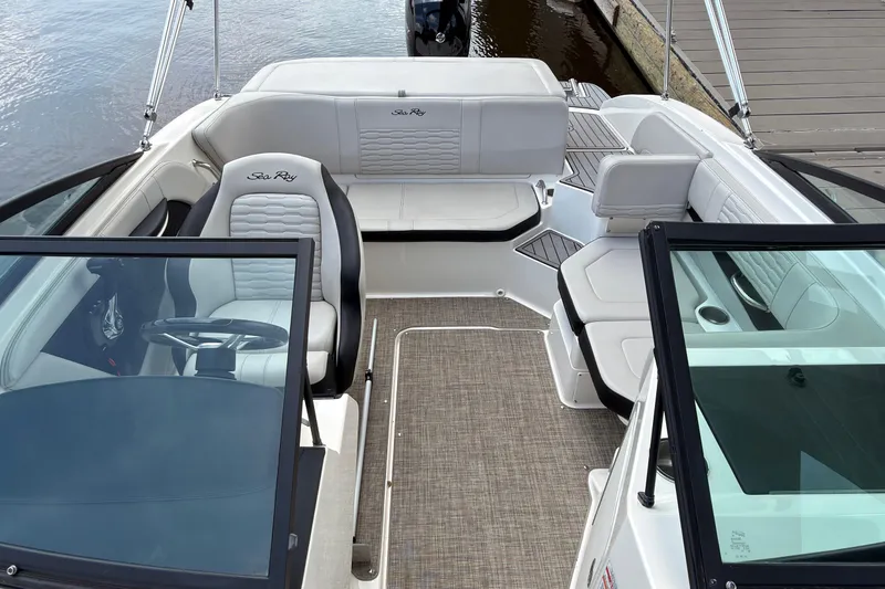 Slide: The Image of 2021 Sea Ray SPX 190 boat interior with white seating and steering wheel. - 6