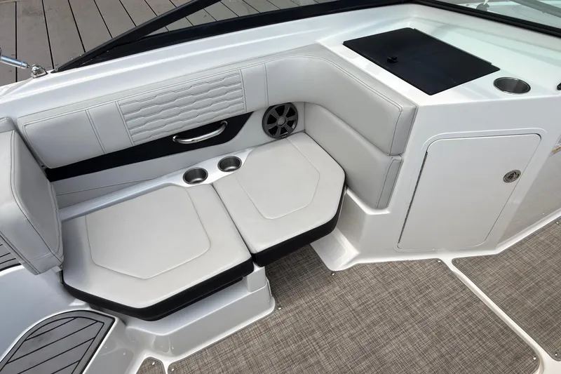 Slide: The Image of 2021 Sea Ray SPX 190 boat interior with cushioned seating and cup holders. - 9