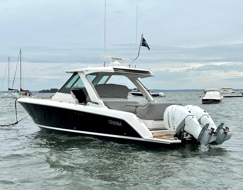 Slide: The Image of 2020 Tiara Sport 34 LS boat on water, featuring sleek design and powerful engines. - 27