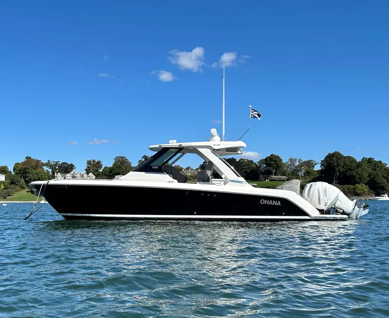 Slide: The Image of 2020 Tiara Sport 34 LS boat on water, clear sky, scenic background. - 3