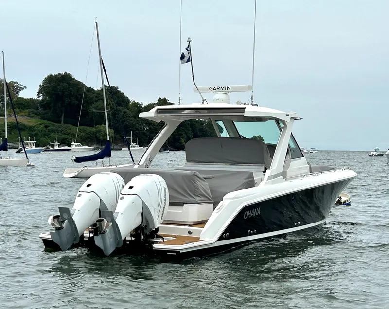 Slide: The Image of 2020 Tiara Sport 34 LS boat with twin engines on a calm lake. - 7