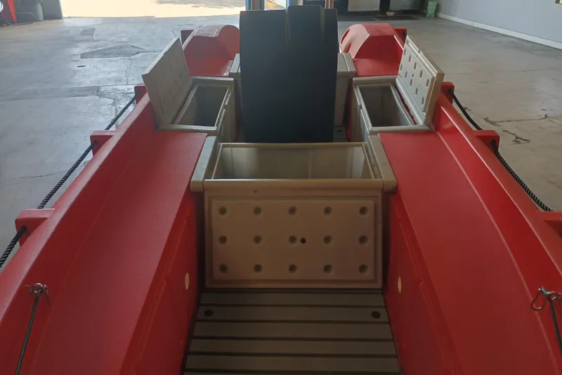 Slide: The Image of 2024 Whaly 455R boat interior with storage compartments, red hull, and durable design. - 12