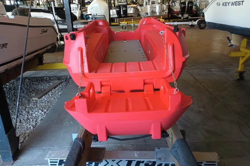 Slide: The Image of 2024 Whaly 455R red boat displayed in a showroom with other vessels. - 5