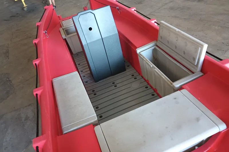 Slide: The Image of 2024 Whaly 455R boat interior with red hull and storage compartments. - 10