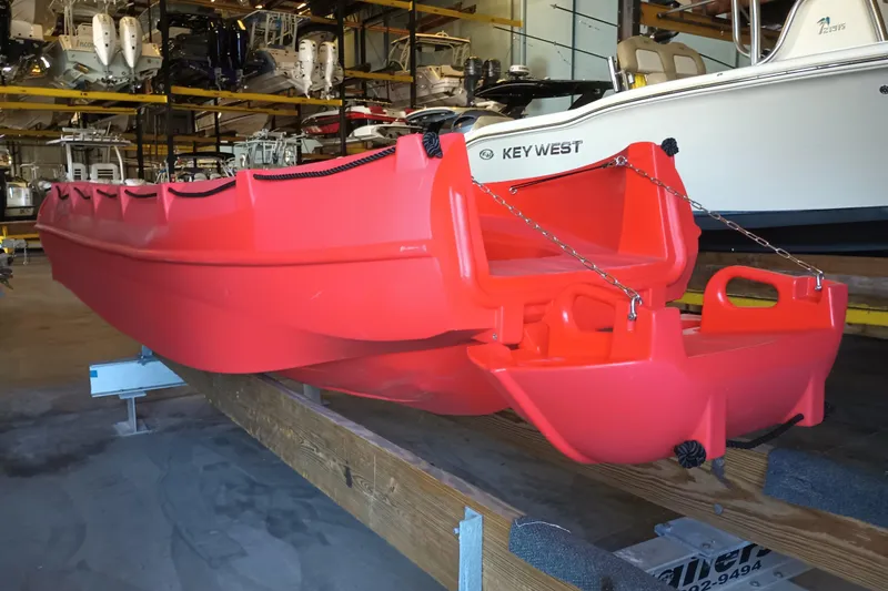 Slide: The Image of 2024 Whaly 455R red boat displayed indoors, showcasing its robust design and vibrant color. - 6
