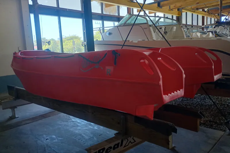 Slide: The Image of Red 2024 Whaly 455R boat displayed indoors, highlighting its robust design and vibrant color. - 8