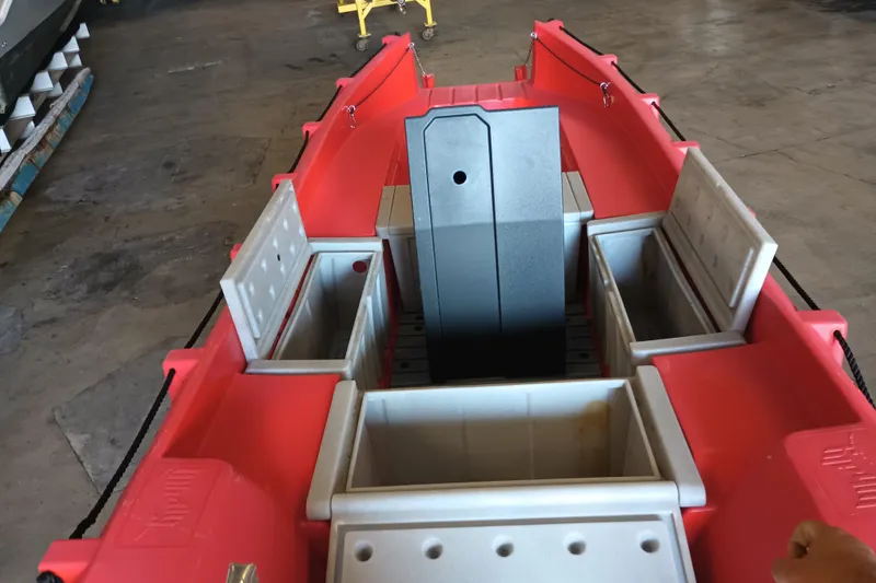 Slide: The Image of 2024 Whaly 455R boat interior with storage compartments, red and gray design. - 9