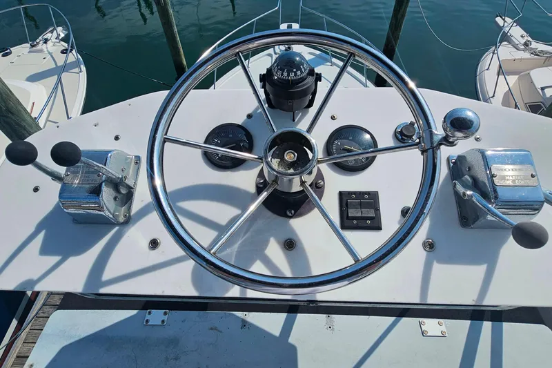 Slide: The Image of Steering wheel and controls of a 1988 Rampage 31 Express boat. - 10