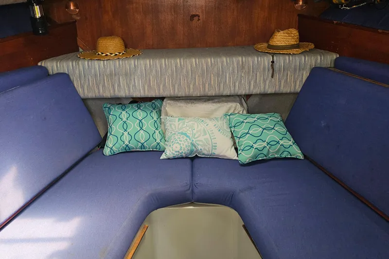 Slide: The Image of Interior of 1988 Rampage 31 Express boat with blue cushions and decorative pillows. - 15