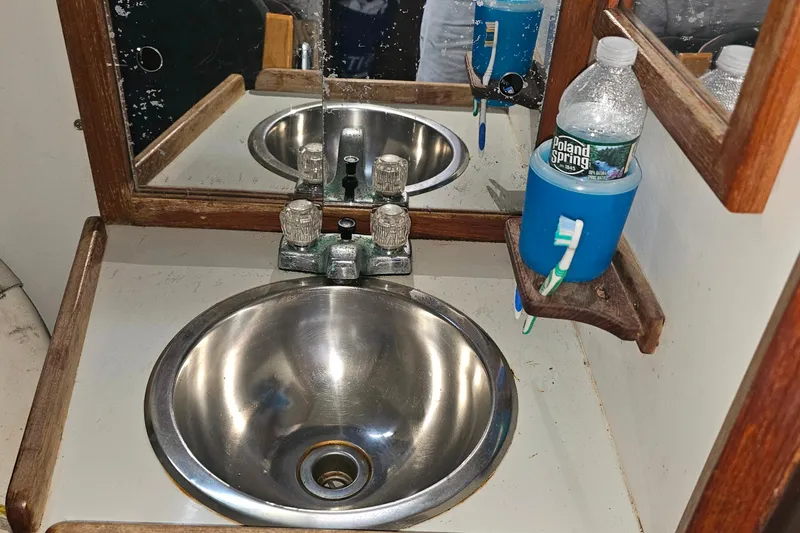 Slide: The Image of Stainless steel sink with wooden trim in 1988 Rampage 31 Express boat bathroom. - 17